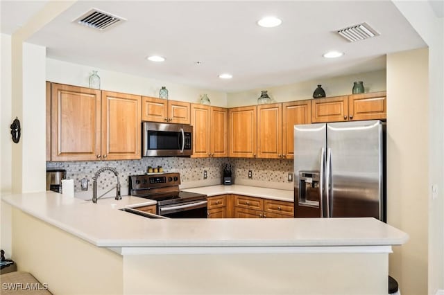 1520 SW 50th St Unit 202, Cape Coral, FL 33914 - kitchen featuring stainless steel appliances, a peninsula, light countertops, decorative backsplash, and recessed lighting
