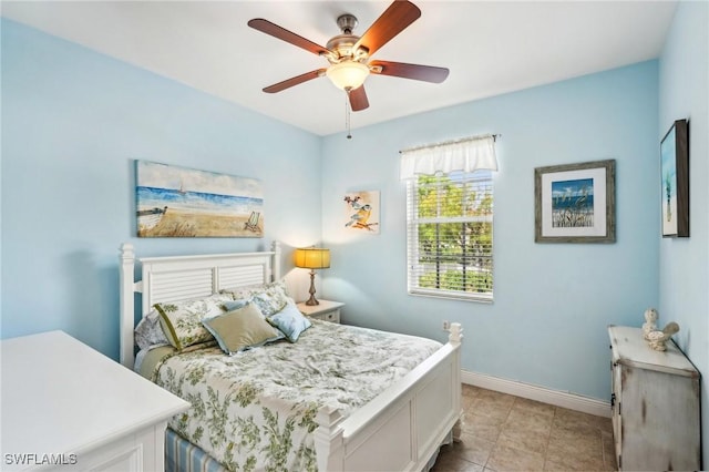 1520 SW 50th St Unit 202, Cape Coral, FL 33914 - bedroom featuring baseboards, light tile patterned flooring, and a ceiling fan