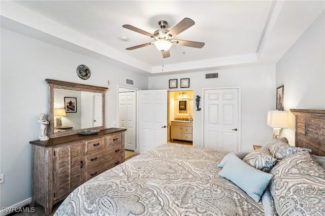 1520 SW 50th St Unit 202, Cape Coral, FL 33914 - bedroom with a tray ceiling, ceiling fan, and ensuite bathroom