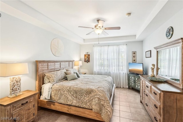 1520 SW 50th St Unit 202, Cape Coral, FL 33914 - bedroom featuring a tray ceiling, light tile patterned flooring, and ceiling fan