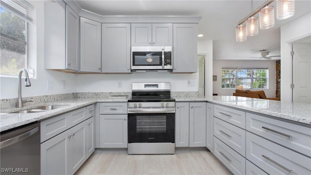 767 Glendale Ave, Naples, FL 34110 - kitchen featuring appliances with stainless steel finishes, ceiling fan, light stone countertops, recessed lighting, and pendant lighting