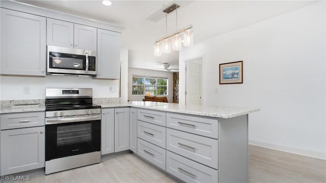 767 Glendale Ave, Naples, FL 34110 - kitchen featuring stainless steel appliances, a peninsula, light wood-style floors, light stone counters, and recessed lighting