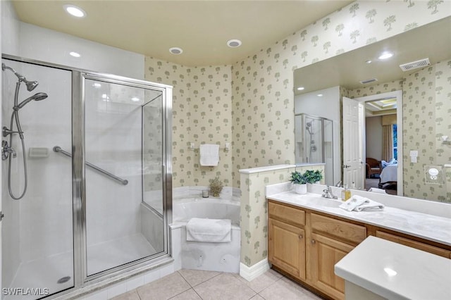 ensuite bathroom featuring wallpapered walls, a stall shower, tile patterned flooring, vanity, and a garden tub