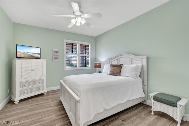 bedroom with baseboards, light wood-type flooring, and ceiling fan
