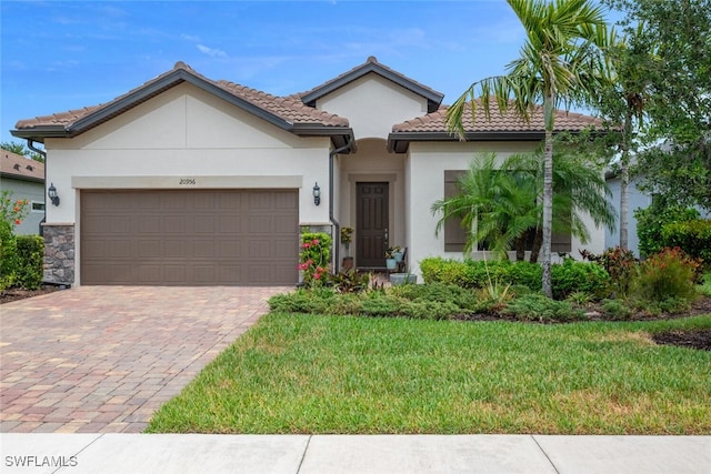 20956 Corkscrew Shores Blvd E, Estero, FL 33928 - mediterranean / spanish-style home featuring stucco siding, driveway, a garage, and a front lawn