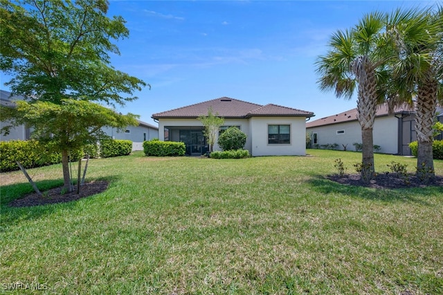 20956 Corkscrew Shores Blvd E, Estero, FL 33928 - view of front of house featuring stucco siding, a front lawn, and a tiled roof