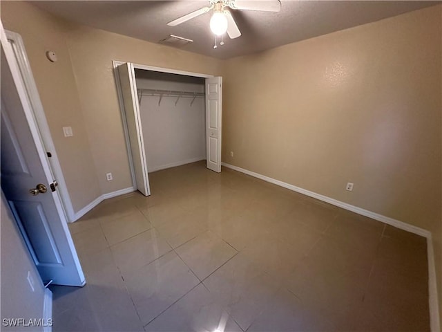 5550 Birdsong Ln, Bokeelia, FL 33922 - unfurnished bedroom with tile patterned floors, baseboards, a closet, and ceiling fan