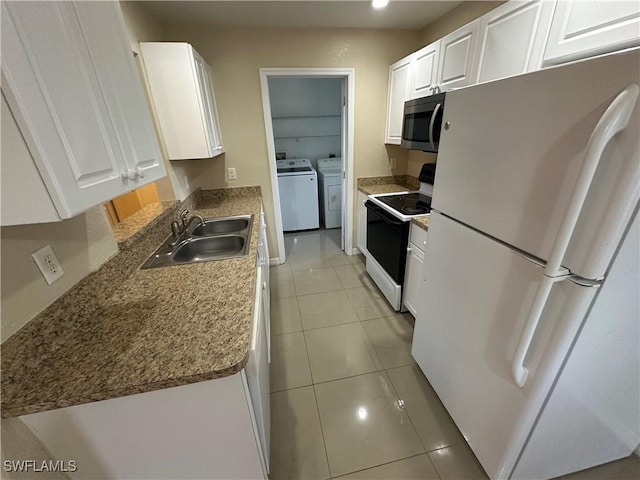 5550 Birdsong Ln, Bokeelia, FL 33922 - kitchen with freestanding refrigerator, range with electric cooktop, washing machine and dryer, stainless steel microwave, and a sink