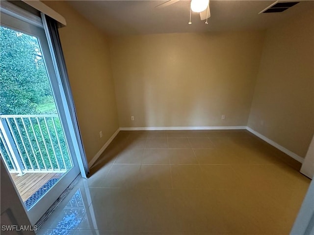 5550 Birdsong Ln, Bokeelia, FL 33922 - empty room featuring ceiling fan, light tile patterned flooring, and baseboards