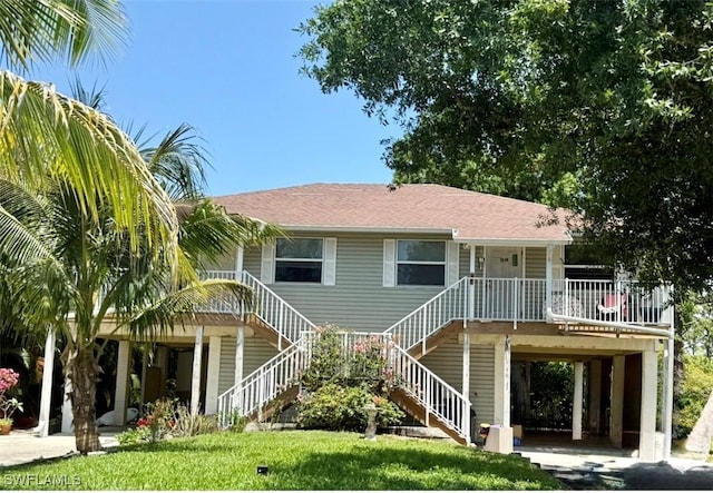 5550 Birdsong Ln, Bokeelia, FL 33922 - rear view of property with covered porch and stairway
