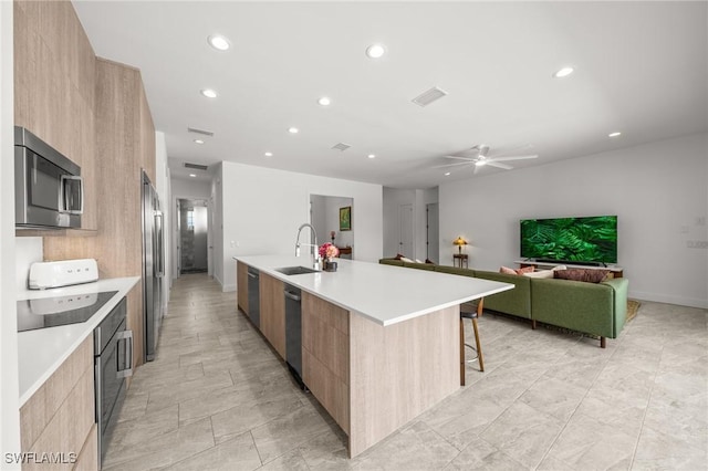 14931 David Dr, Fort Myers, FL 33908 - kitchen with modern cabinets, appliances with stainless steel finishes, light brown cabinetry, and recessed lighting