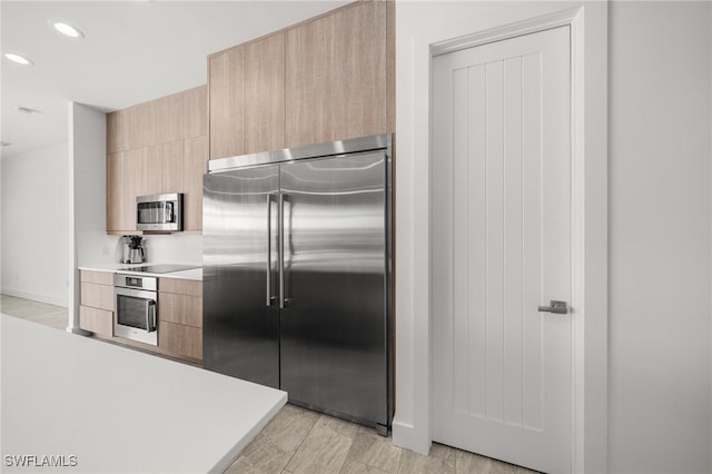 14931 David Dr, Fort Myers, FL 33908 - kitchen with appliances with stainless steel finishes, light brown cabinetry, modern cabinets, light countertops, and recessed lighting