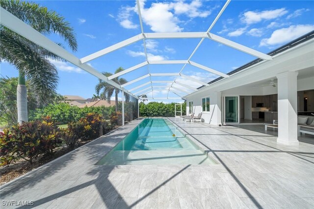14931 David Dr, Fort Myers, FL 33908 - outdoor pool featuring a patio, a ceiling fan, and glass enclosure