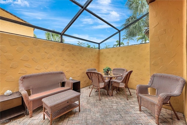 view of patio featuring a lanai and outdoor dining area
