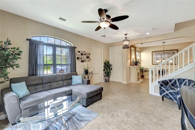 living area featuring a chandelier, a ceiling fan, stairs, light tile patterned floors, and recessed lighting
