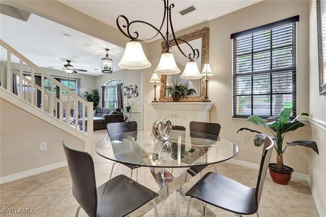 tiled dining room featuring stairs, baseboards, and ceiling fan