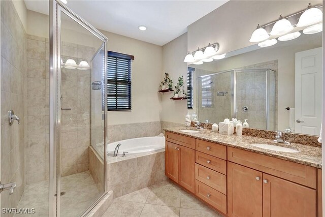 bathroom with a shower stall, a bath, tile patterned floors, double vanity, and recessed lighting