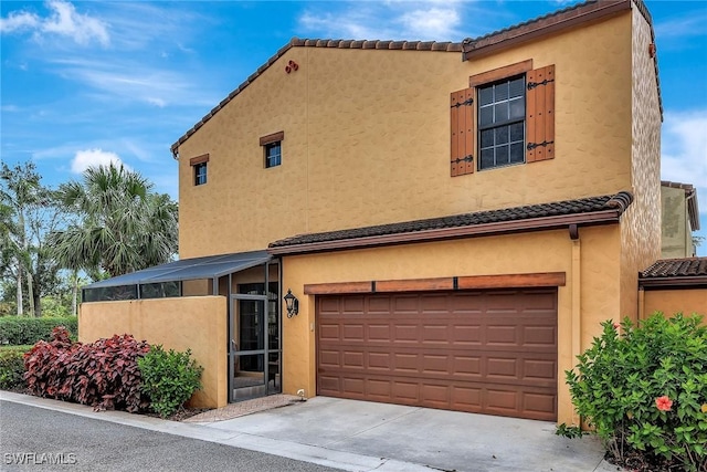 view of front of property with a garage, a tile roof, and stucco siding
