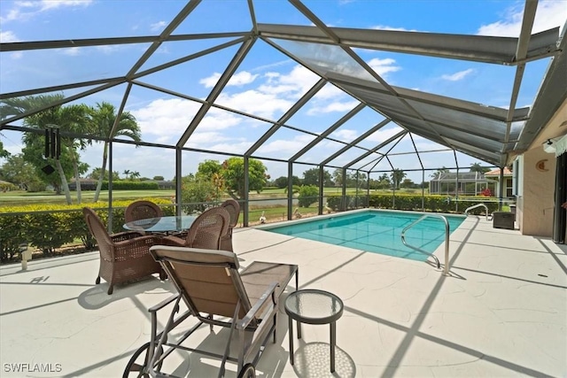 outdoor pool featuring a patio, outdoor dining area, and a lanai