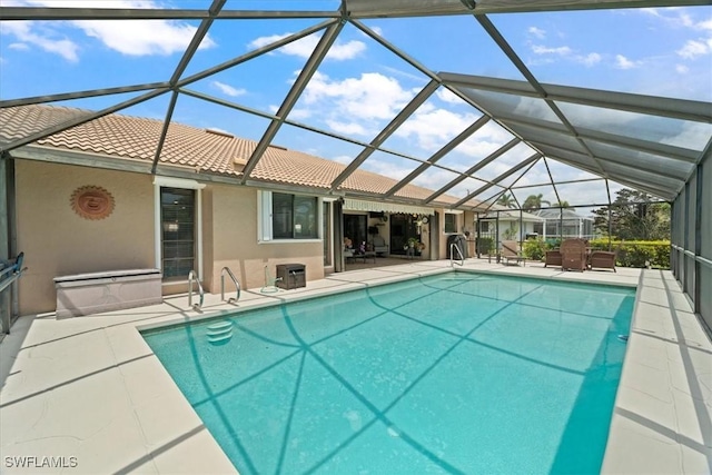 outdoor pool featuring a patio area and glass enclosure