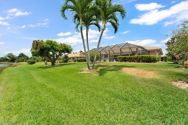 view of green lawn featuring a lanai