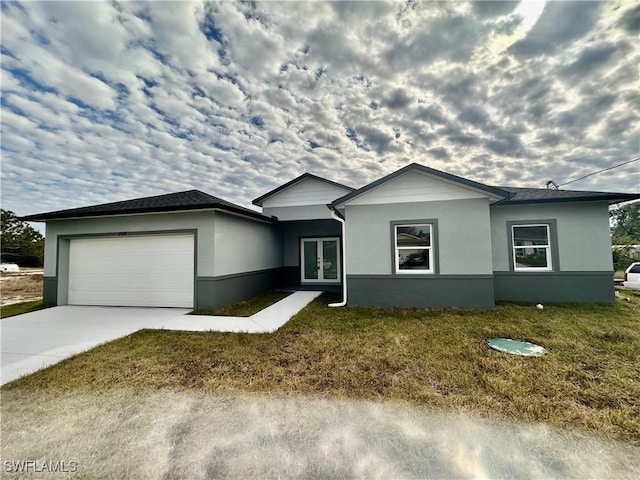 ranch-style home with french doors, stucco siding, an attached garage, and driveway