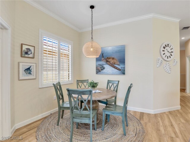 8532 Via Lungomare Cir Unit 203, Estero, FL 33928 - dining room featuring wood finished floors, crown molding, and baseboards