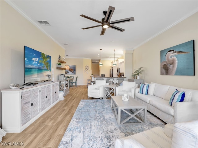 8532 Via Lungomare Cir Unit 203, Estero, FL 33928 - living area featuring ornamental molding, light wood finished floors, ceiling fan, and baseboards