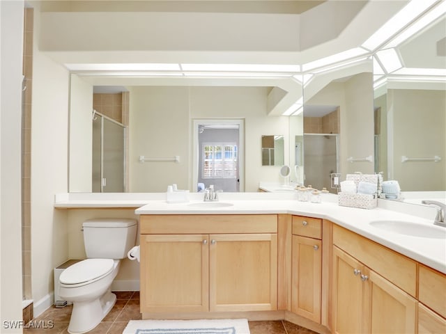 8532 Via Lungomare Cir Unit 203, Estero, FL 33928 - bathroom with a shower stall, toilet, tile patterned floors, and double vanity