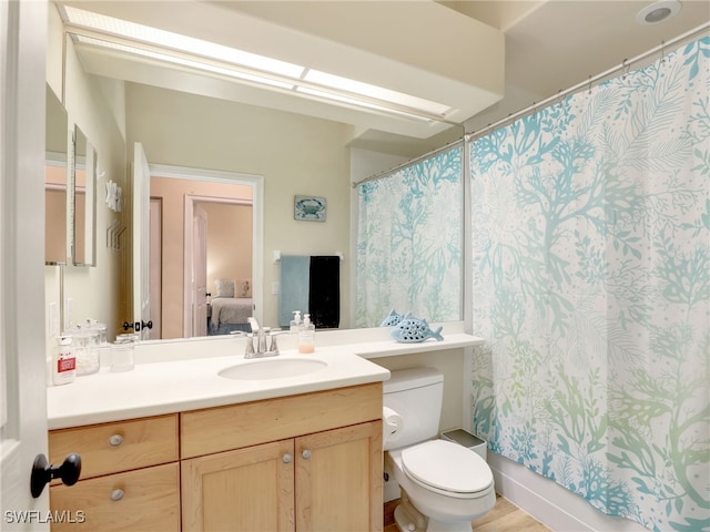 8532 Via Lungomare Cir Unit 203, Estero, FL 33928 - full bathroom with vanity, toilet, ensuite bathroom, and a shower with shower curtain
