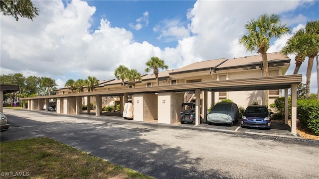 5825 Trailwinds Dr Unit 425, Fort Myers, FL 33907 - view of front facade with stucco siding and covered parking