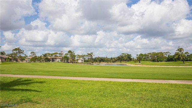 5825 Trailwinds Dr Unit 425, Fort Myers, FL 33907 - view of property's community with golf course view, a water view, and a lawn