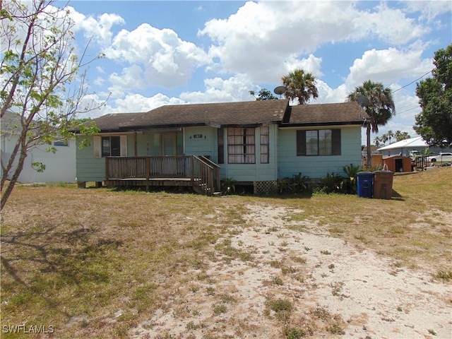 ranch-style home featuring a front yard and a porch