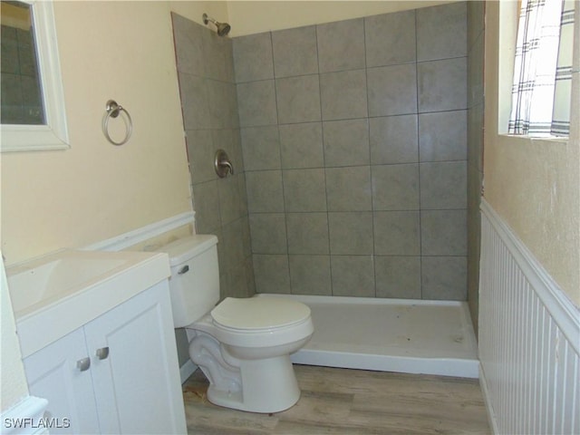 full bathroom with toilet, a shower stall, vanity, and wood finished floors