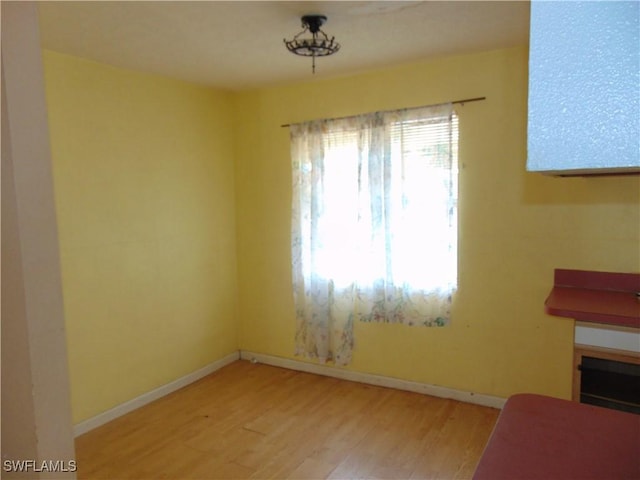 dining space featuring wood finished floors and baseboards