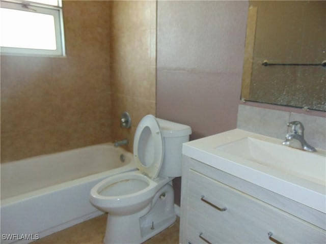 bathroom featuring toilet, vanity, and shower / washtub combination