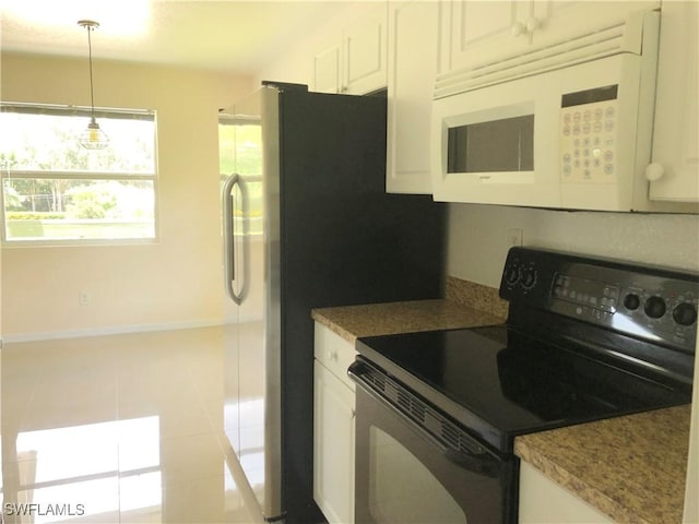 5615 Birdsong Ln, Bokeelia, FL 33922 - kitchen featuring black electric range oven, white microwave, hanging light fixtures, light tile patterned floors, and white cabinetry
