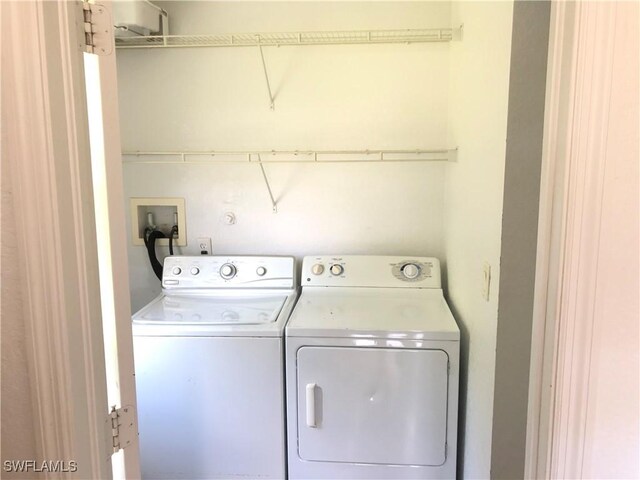 5615 Birdsong Ln, Bokeelia, FL 33922 - laundry room featuring washer and dryer