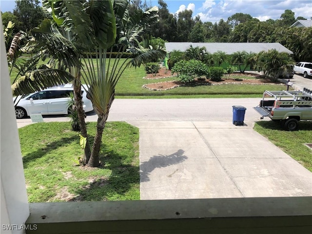 5615 Birdsong Ln, Bokeelia, FL 33922 - view of grassy yard featuring concrete driveway