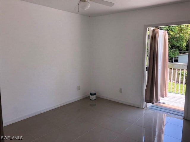 5615 Birdsong Ln, Bokeelia, FL 33922 - empty room with ceiling fan, light tile patterned flooring, and baseboards