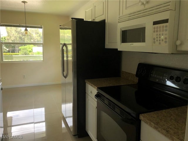 5615 Birdsong Ln, Bokeelia, FL 33922 - kitchen with black / electric stove, white microwave, light tile patterned floors, white cabinetry, and decorative light fixtures