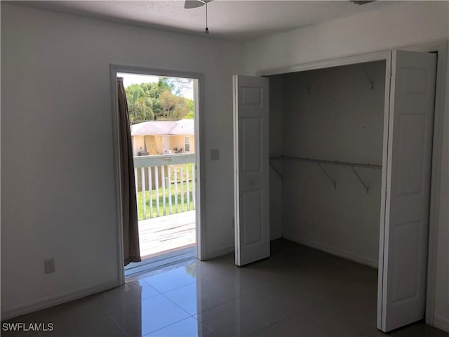 5615 Birdsong Ln, Bokeelia, FL 33922 - doorway to outside with tile patterned flooring, baseboards, and a ceiling fan