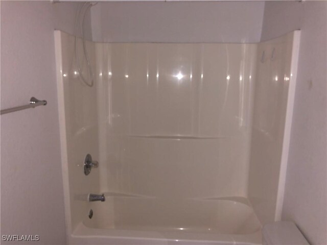 5615 Birdsong Ln, Bokeelia, FL 33922 - bathroom with shower / washtub combination and toilet
