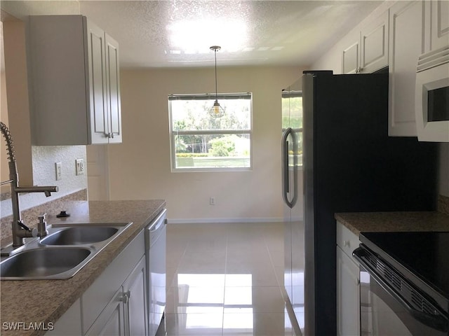 5615 Birdsong Ln, Bokeelia, FL 33922 - kitchen featuring black electric range oven, dishwasher, baseboards, white microwave, and a textured ceiling