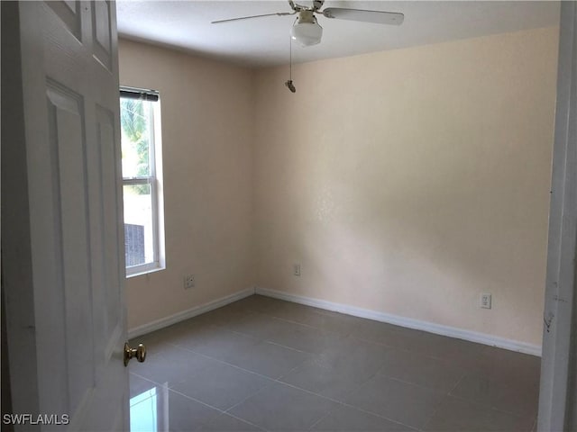 5615 Birdsong Ln, Bokeelia, FL 33922 - empty room featuring ceiling fan, tile patterned floors, and baseboards