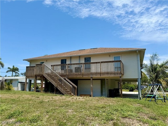 5615 Birdsong Ln, Bokeelia, FL 33922 - rear view of house featuring a garage, a lawn, a deck, and stairway