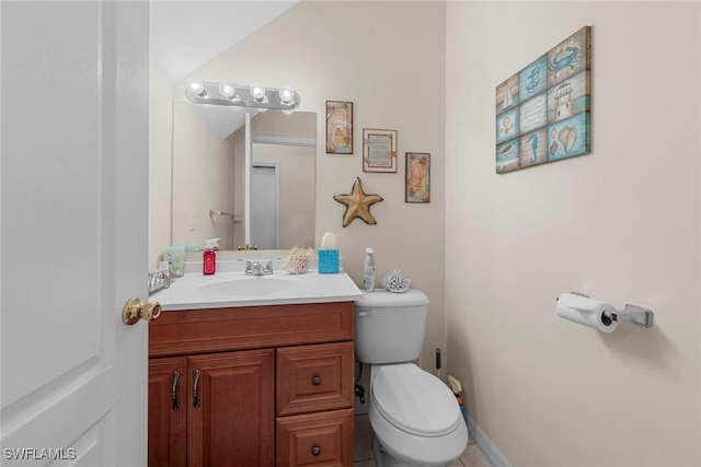 half bath featuring vanity and toilet