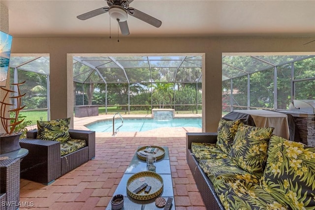 swimming pool with a patio area, grilling area, a lanai, and ceiling fan