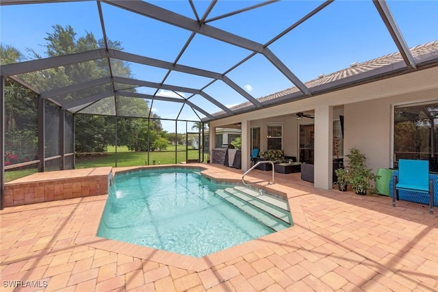 swimming pool featuring a patio, a ceiling fan, and glass enclosure