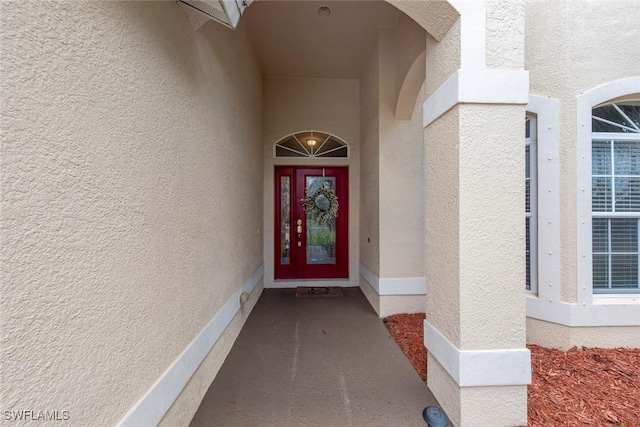 property entrance with stucco siding